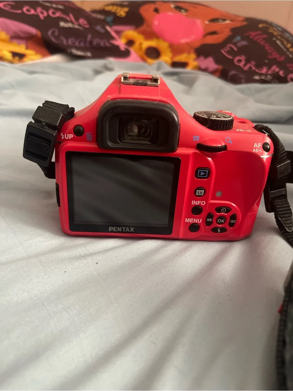 Pentax Red DSLR with Black Strap and 18-55mm Lens